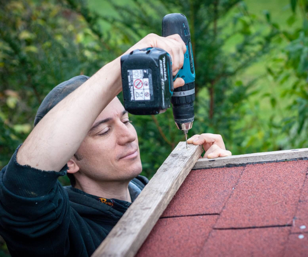 Florian Hucht schraubt ein Dach zusammen.
